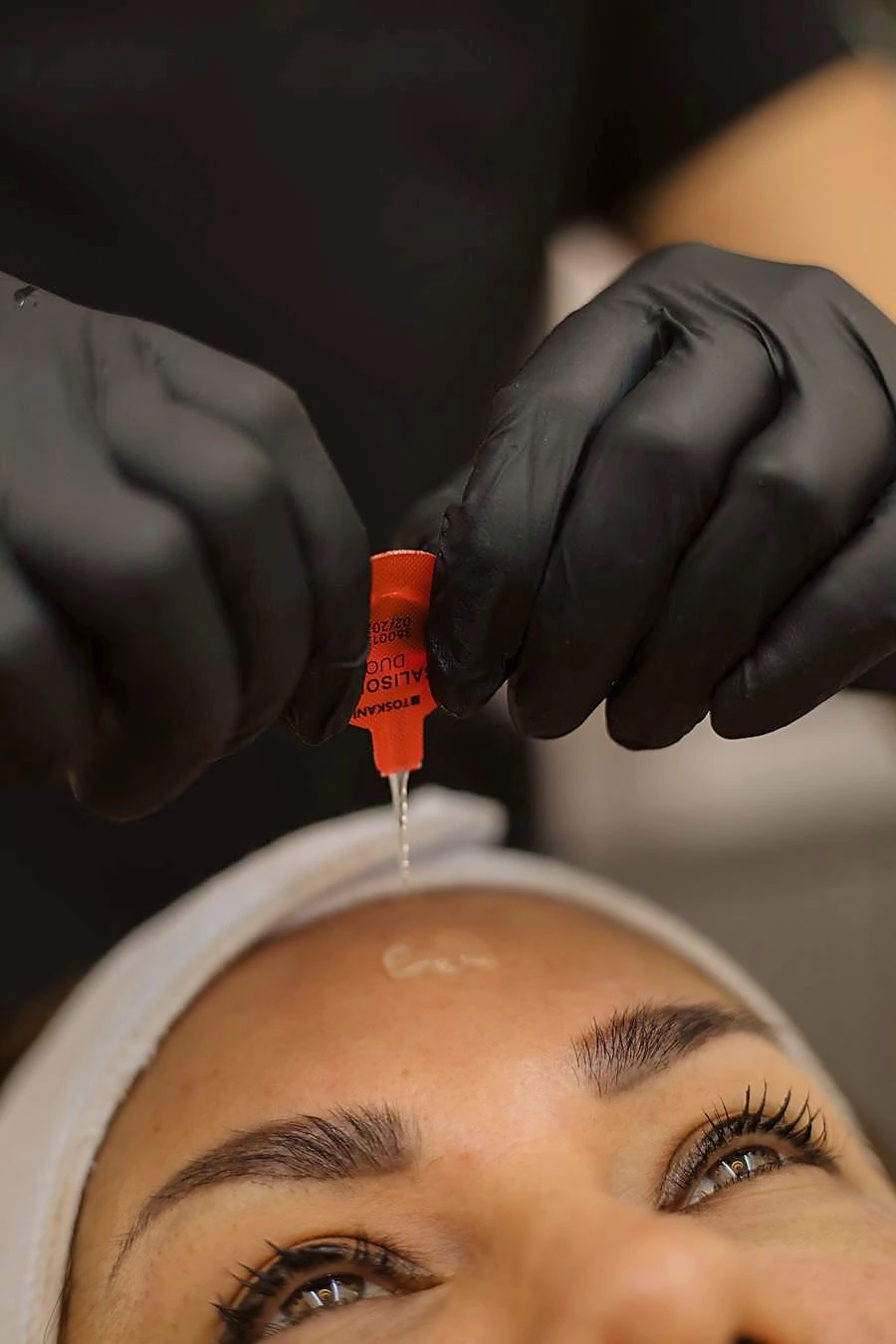 A medical peel being carefully applied during a facial treatment