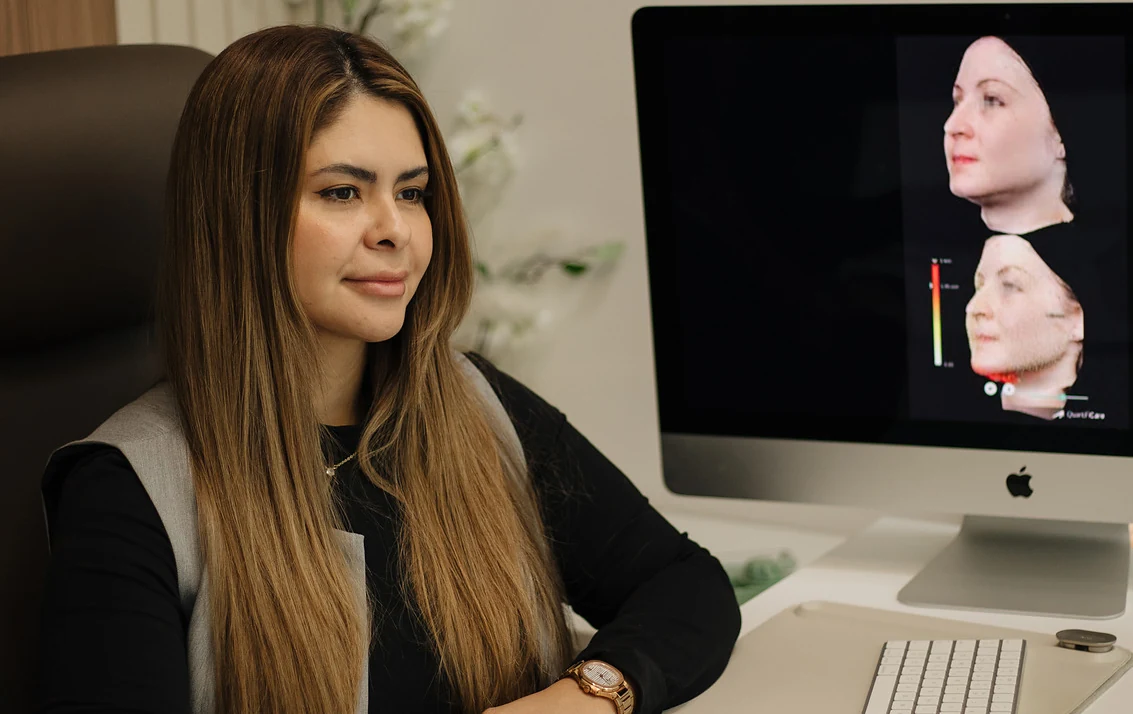Dr. Sibaja studying a patient's 3D facial analysis before composing their protocol